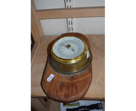 Brass cased barometer on wooden back