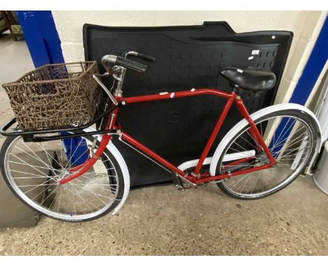 Vintage red painted bicycle with basket