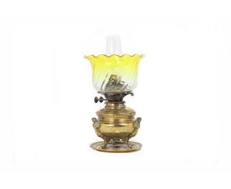 A VICTORIAN BRASS OIL LAMP
Comes with citrine-coloured fluted edge glass shade and base with repousse designs on three suppor