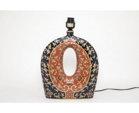 A CIRCULAR PIERCED CERAMIC LAMP
In orange and black, with foliate decoration
Measures 47cm high x 35cm wide (without shade)
C