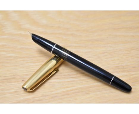 An Aurora 88P piston fill fountain pen in black with gold cap