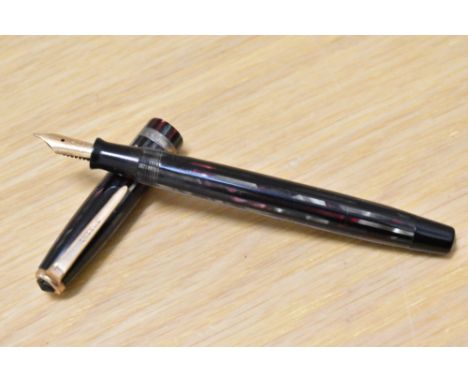 A Parker Duofold Geometric button fill fountain pen in in red, silver and black striated pattern with a broad band to the cap