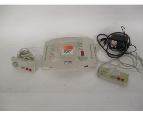 An Amstrad GX4000 game console with hand controllers and Burnin Rubber games 