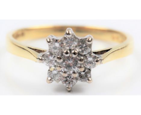 A hallmarked 18ct yellow gold diamond flower cluster design ring, set with nine round brilliant cut diamonds, total diamond w