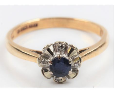 A hallmarked 9ct yellow gold sapphire and diamond flower design ring, set with a central round cut sapphire surrounded by fou