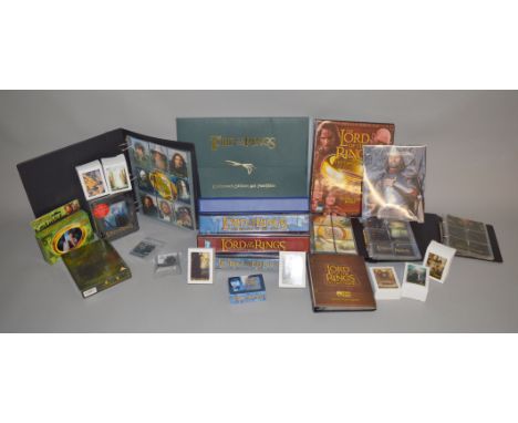 A collection of Lord of The Rings items, which includes; Collectors edition art portfolio, Colltors cards plus collectors alb