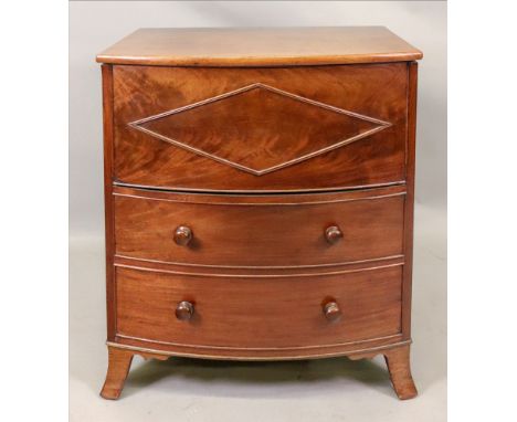 An Early 19th century mahogany bowfront commode, with rising top and front above two dummy drawers, 63cm wide x 48cm deep x 7