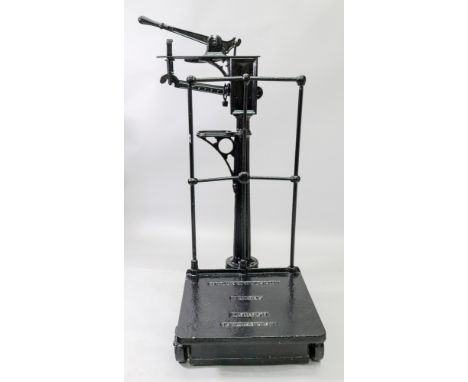 Baker &amp; Walsh Ltd; a set of cast iron commercial weighing scales, 51cm wide x 72cm deep x 115cm high.