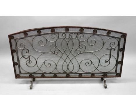 A large arched top rectangular wrought iron and mesh fireguard, 128cm wide x 72cm high.