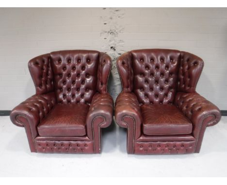 A pair of button leather Chesterfield wing back armchairs 