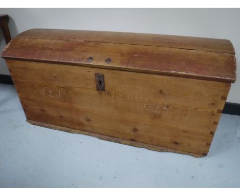 An antique pine dome topped shipping trunk 