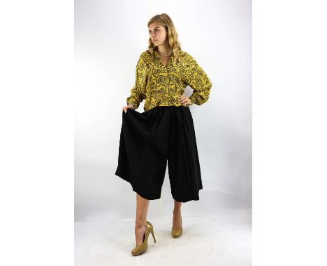 GIANNI VERSACE A collection of ladies clothing dating from the 1980s-90s. A two pairs of black wool pleated culottes with a t