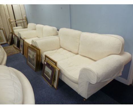 A LOUNGE SUITE OF FOUR PIECES, COVERED IN WHITE LINING AND THE CREAM EMBOSSED SELF COLOURED COVERS, VIZ, A THREE SEATER SETTE