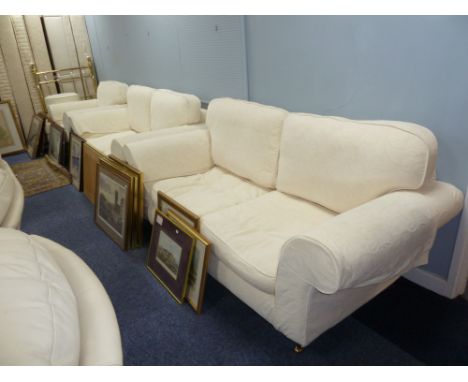 A LOUNGE SUITE OF FOUR PIECES, COVERED IN WHITE LINING AND THE CREAM EMBOSSED SELF COLOURED COVERS, VIZ, A THREE SEATER SETTE