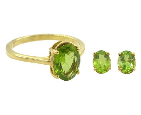 Gold single stone oval cut peridot ring and a similar pair of peridot earrings, both 18ctCondition Report:Approx 4.25gm, all 