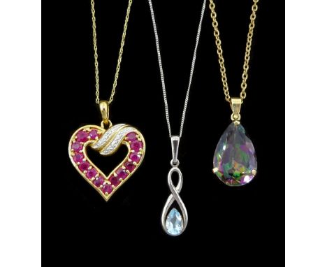 White gold single stone blue topaz pendant necklace, ruby and diamond pendant necklace and a gold mystic topaz pendant, all 9