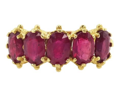 18ct gold five stone oval cut glass-filled ruby ring, with scroll design shoulders, London 2005Condition Report:Approx 5.25gm