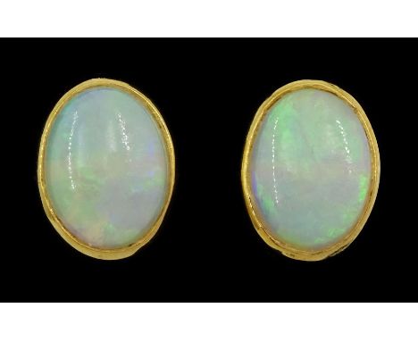 Pair of 18ct gold opal stud earrings, hallmarkedCondition Report:Approx 2.4gm, dimensions = 10mm x 7.5mm, some light rubbing 