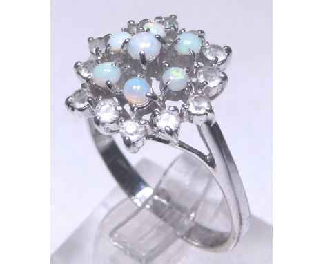 OPAL FLOWER RING. White metal opal and stone set flower head ring