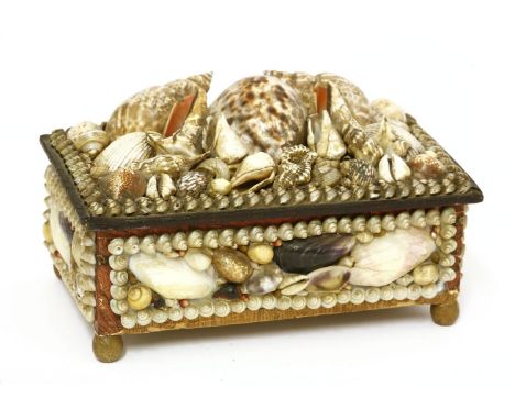 A shell-mounted 'sailor's valentine' dressing table box,19th century, the hinged top mounted with a mirror, the tin-lined int