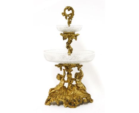 A gilt bronze centrepiece,mid-19th century, with two crisply cut bowls on a fruiting vine centre supported by two putti on an
