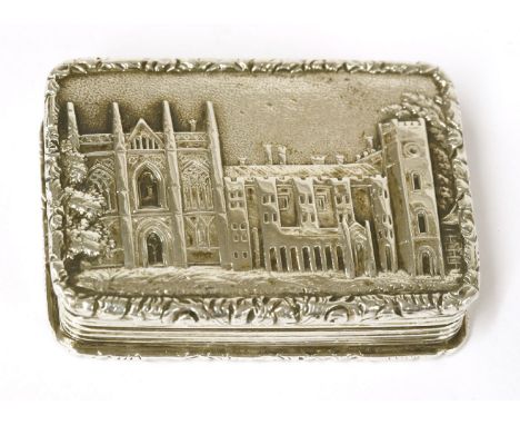 A George IV silver castle top vinaigrette, Nathanial Mills, Birmingham, 1829, the hinged cover chased with a view of Newstead
