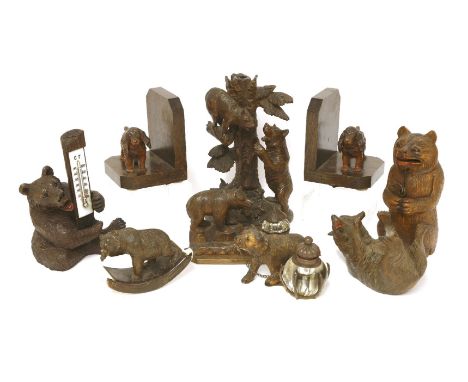 A collection of Black Forest bear items,variously carved with bears modelled as desk stands, a desk thermometer, a blotter,24
