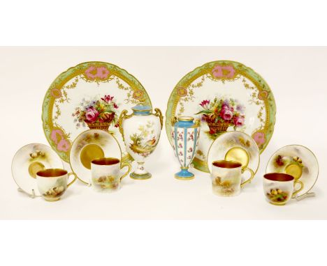 A pair of Spode Copeland porcelain plates, each painted with a basket of flowers within green, gilt and pink borders, with bu