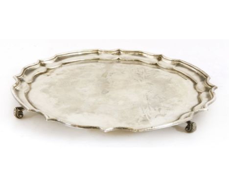 A silver salver, maker BRS, Sheffield 1959,with a Chippendale shaped border on scrolled feet,35.5cm diameter, 37oz approximat