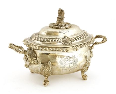 A George III silver two-handled sauce tureen and cover,WB, London 1818,of oval form, raised on four naturalistic shell and sc