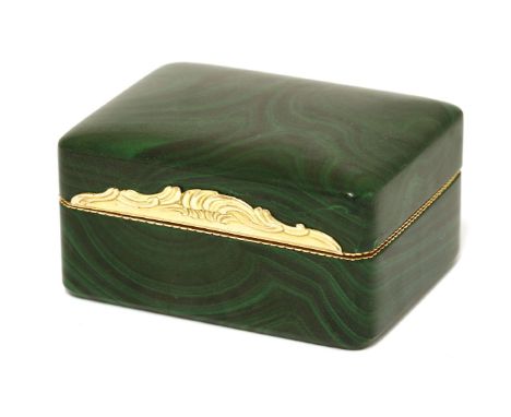 A malachite and gold miniature dressing table box,probably French, 19th century,the hinged lid with an ornate gold mount and 