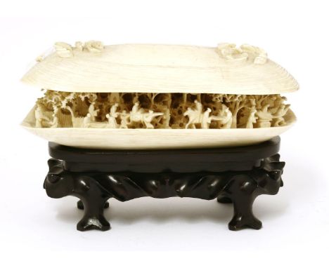 A Chinese ivory shell dream,late 19th century, the bivalve opening to reveal a finely carved and pierced scene of figures, ei