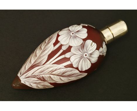 A cameo glass scent bottle,by Thomas Webb & Co, Stourbridge, the ruby glass of teardrop shape overlaid in white with flowers 