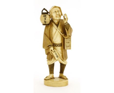 A Japanese ivory okimono,Meiji period (1868-1912), of a merchant selling tsujiura, his left hand raised by his mouth, carryin