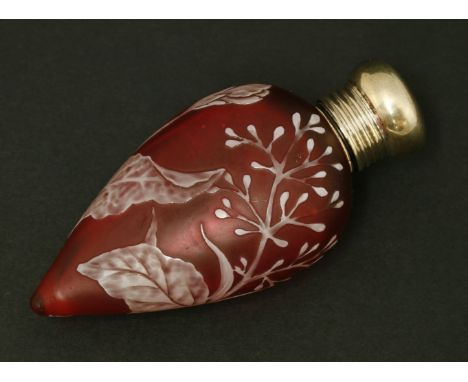 A cameo glass scent bottle, by Thomas Webb & Co, Stourbridge, the ruby glass of teardrop shape overlaid in white with flowers