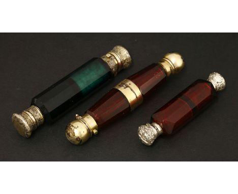 Three Victorian coloured glass double-ended scent bottles,one ruby glass with a central vinaigrette and gilt metal mounts,13.