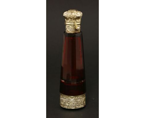 A Victorian ruby glass combination scent bottle and vinaigrette,with engraved gilt metal mounts, the base ornately engraved a