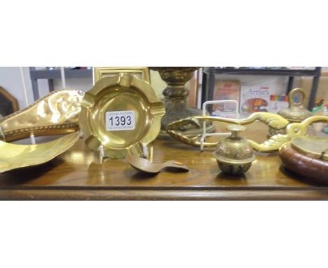 A mixed lot of brassware including coal tongs, powder flask etc.,