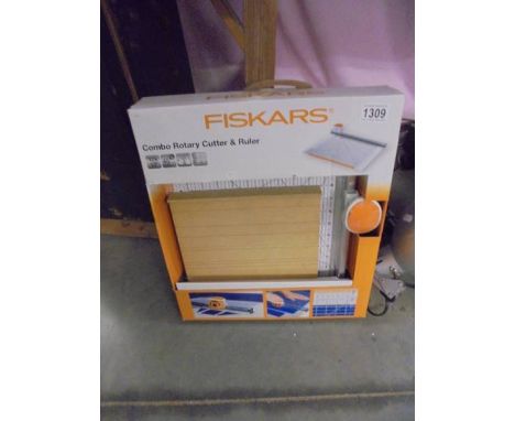 A boxed Fiskers Compo Rotary Cutter &amp; Ruler.