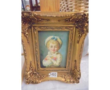 A gilt framed over painted portrait print of a small boy.