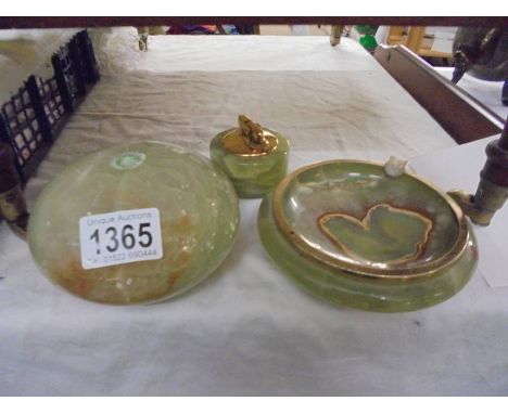 An onyx ashtray, cigarette lighter and one other item.