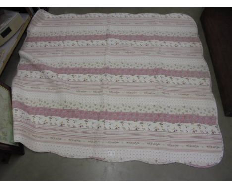 A pink child's cot quilt.