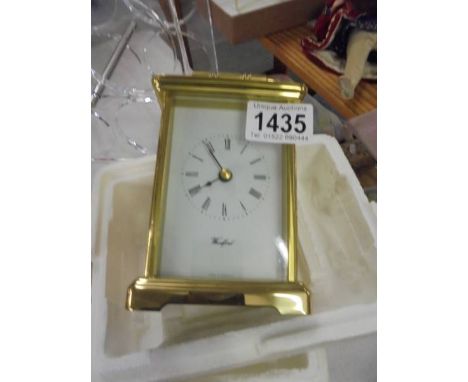 A modern battery brass carriage clock in working order.