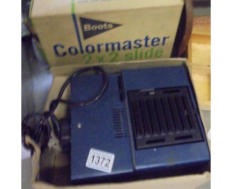 A boxed Boots Colourmaster slide projector.