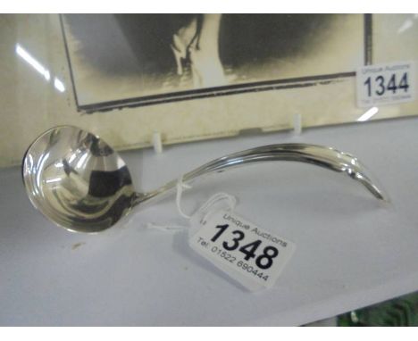 A small silver plate sauce ladle.
