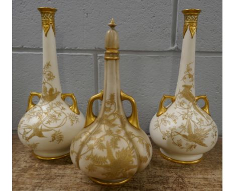 A pair of 19th Century Royal Worcester ivory ground bottle vases decorated with birds and foliage, 36cm, one stopper missing 