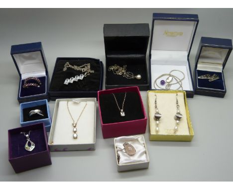 A collection of silver jewellery, pendants, earrings and a ring 