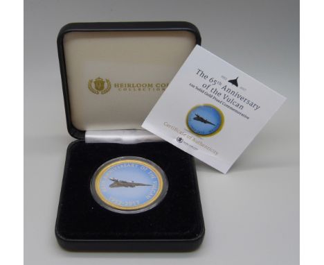 A 1oz solid gold proof commemorative coin, The 65th Anniversary of the Vulcan, 31.10g of 9ct gold, proof quality, with certif