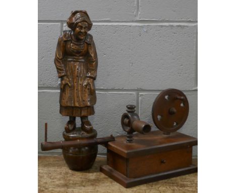 A carved wooden figure of a Dutch lady and a wooden lace bobbin winder 