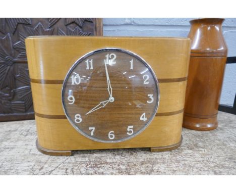 A coin clock, a wooden flask with handle and a carved panel **PLEASE NOTE THIS LOT IS NOT ELIGIBLE FOR POSTING AND PACKING** 